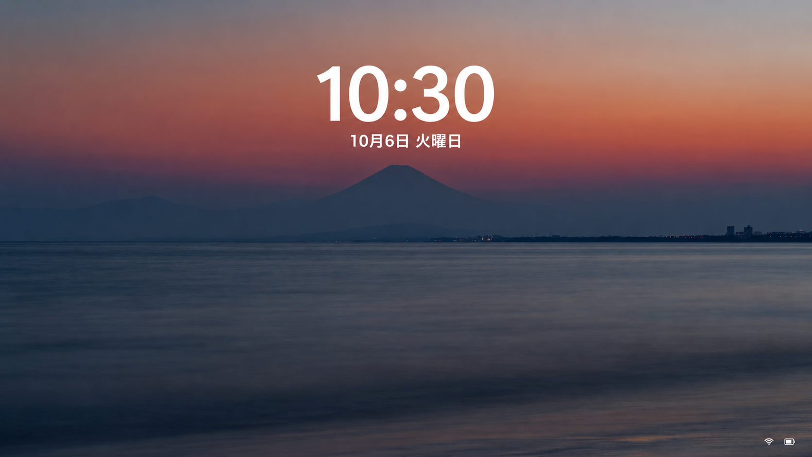 Windows 11のロック画面に風景の背景と10時30分、10月6日火曜日の日付が表示された画面